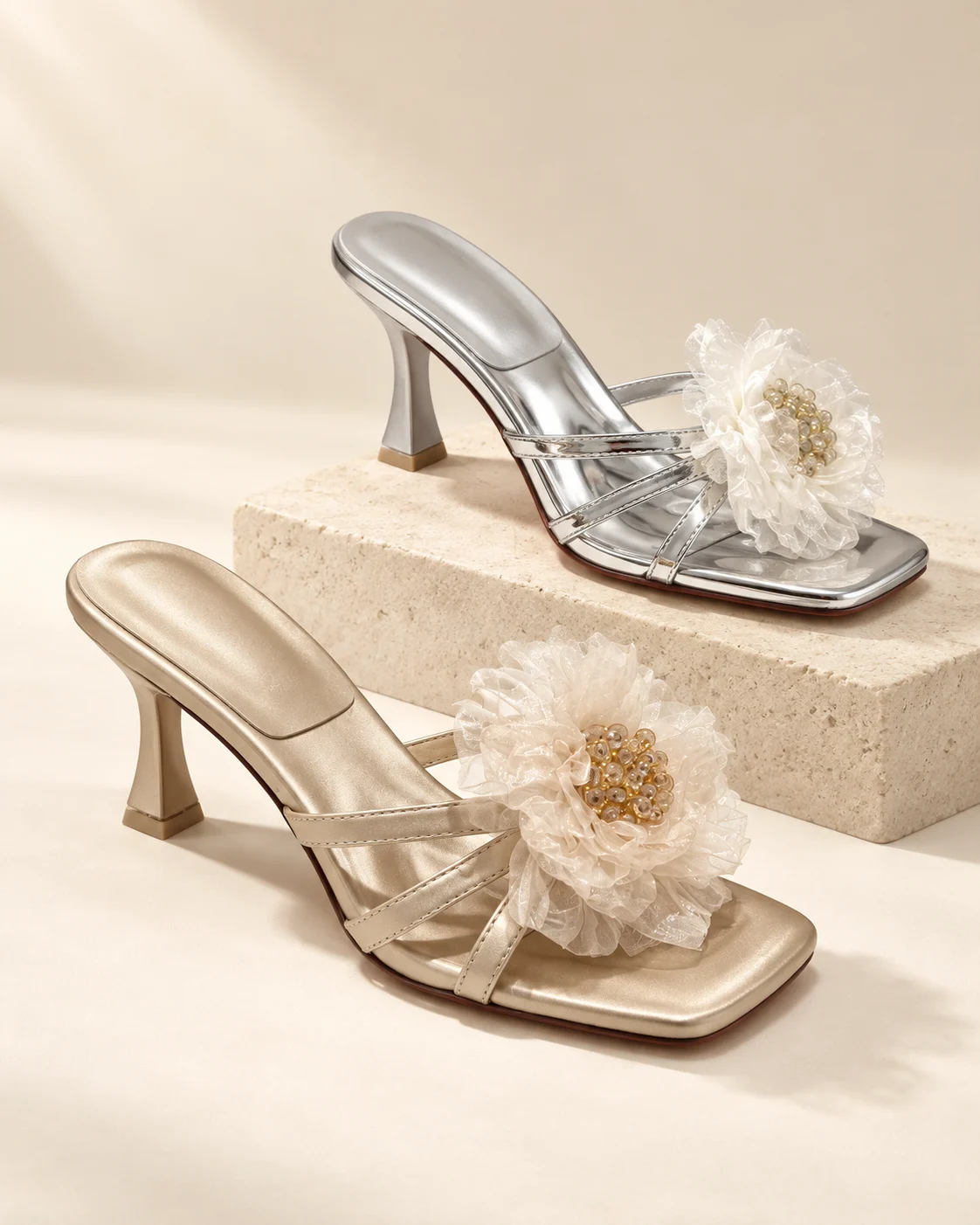 AI-styled studio display of metallic backless mules with organza flowers